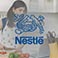 Nestle Logo with woman cooking