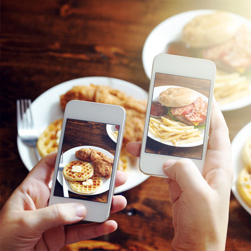 People Taking Pictures of a Meal on Their Phones