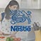 Nestle logo with woman cooking